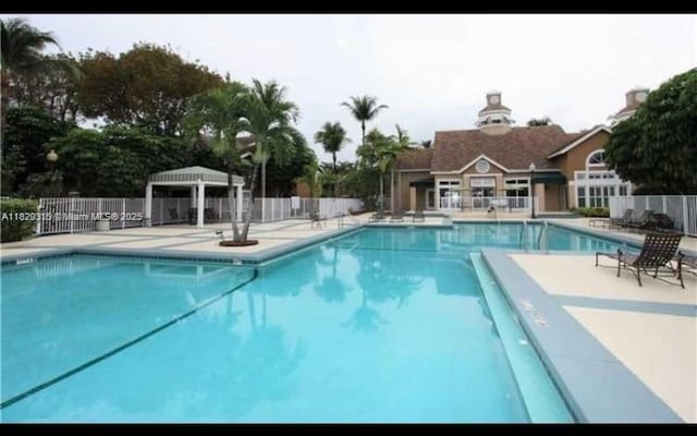 10670 SW 156th Pl Unit 309, Miami, FL 33196 - community pool with a gazebo and a patio