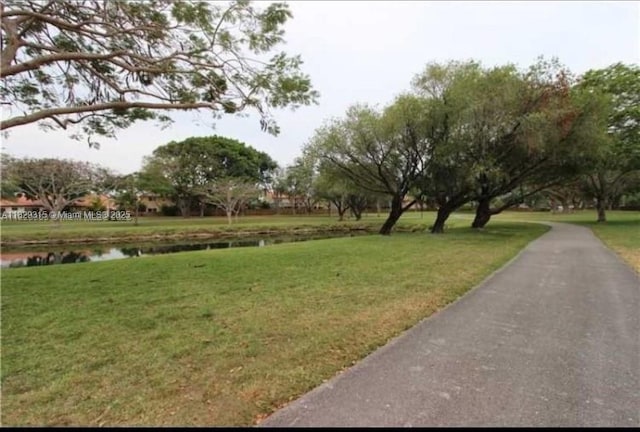 10670 SW 156th Pl Unit 309, Miami, FL 33196 - view of community featuring a yard and a water view