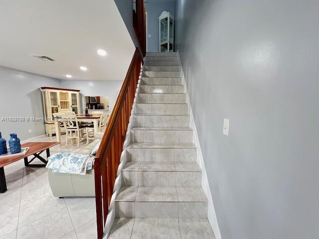 905 NW 107th Ave, Pembroke Pines, FL 33026 - stairway featuring baseboards and recessed lighting