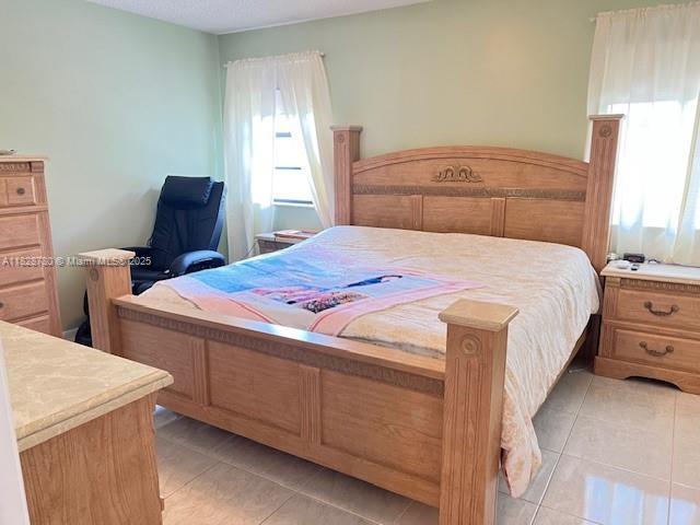 905 NW 107th Ave, Pembroke Pines, FL 33026 - bedroom featuring light tile patterned floors
