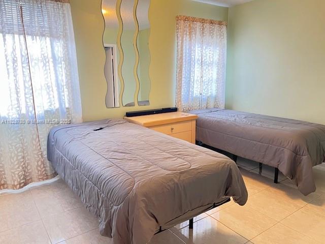 905 NW 107th Ave, Pembroke Pines, FL 33026 - bedroom with light tile patterned floors and multiple windows