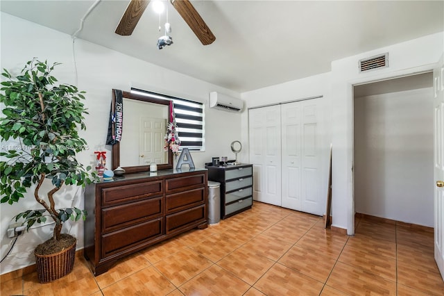8065 W 14th Ct, Hialeah, FL 33014 - bedroom with an AC wall unit, a closet, light tile patterned floors, and ceiling fan