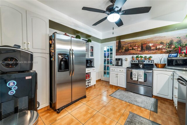8065 W 14th Ct, Hialeah, FL 33014 - kitchen featuring appliances with stainless steel finishes, ceiling fan, white cabinets, light tile patterned floors, and light countertops