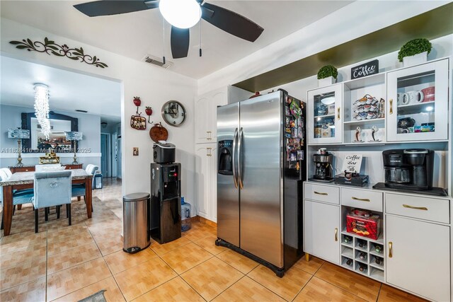 8065 W 14th Ct, Hialeah, FL 33014 - kitchen featuring stainless steel fridge with ice dispenser, a ceiling fan, light tile patterned flooring, white cabinetry, and glass insert cabinets