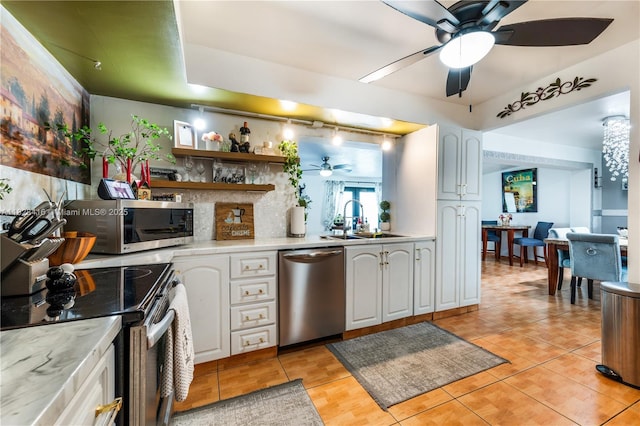 8065 W 14th Ct, Hialeah, FL 33014 - kitchen featuring appliances with stainless steel finishes, ceiling fan, light tile patterned floors, and white cabinetry