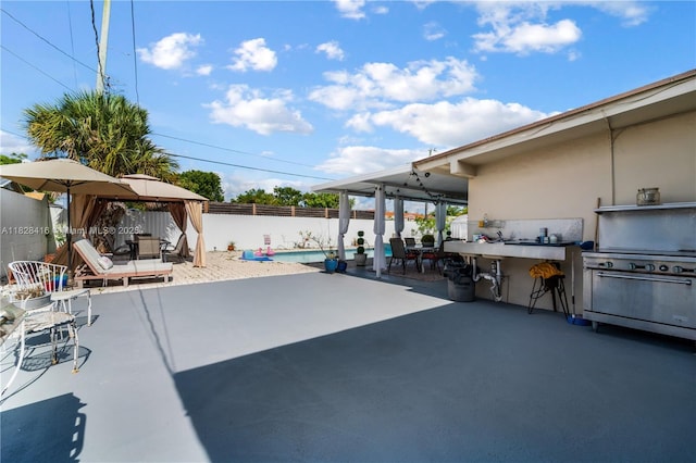 8065 W 14th Ct, Hialeah, FL 33014 - fenced backyard with a gazebo, a patio, and grilling area
