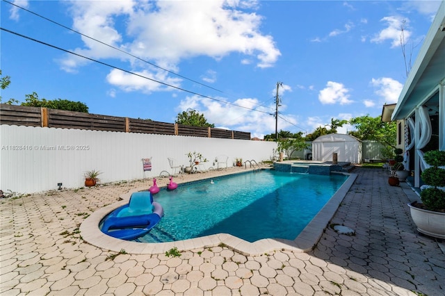 8065 W 14th Ct, Hialeah, FL 33014 - view of swimming pool featuring a fenced backyard, a patio, a pool with connected hot tub, and a shed