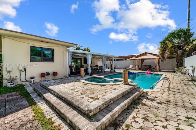 8065 W 14th Ct, Hialeah, FL 33014 - view of swimming pool with a gazebo, a patio area, a fenced backyard, and a pool with connected hot tub