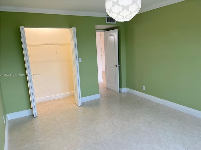 900 NE 18th Ave Unit 304, Fort Lauderdale, FL 33304 - unfurnished bedroom with a chandelier, ornamental molding, light tile patterned floors, and a closet