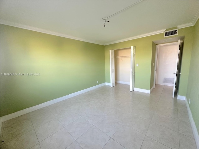 900 NE 18th Ave Unit 304, Fort Lauderdale, FL 33304 - unfurnished bedroom featuring ornamental molding, a closet, light tile patterned flooring, and rail lighting