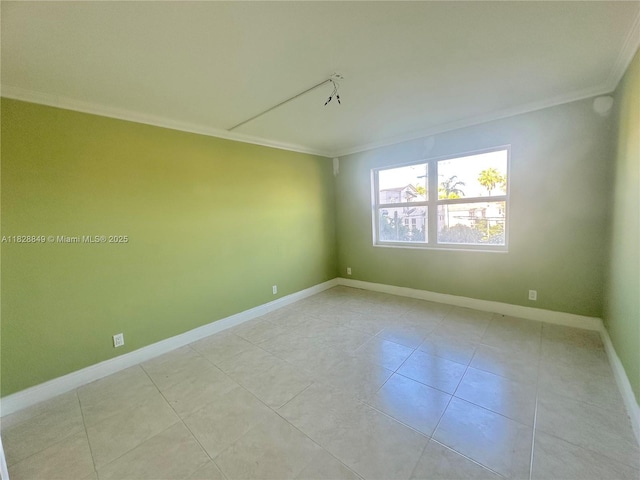 900 NE 18th Ave Unit 304, Fort Lauderdale, FL 33304 - spare room featuring ornamental molding and light tile patterned floors