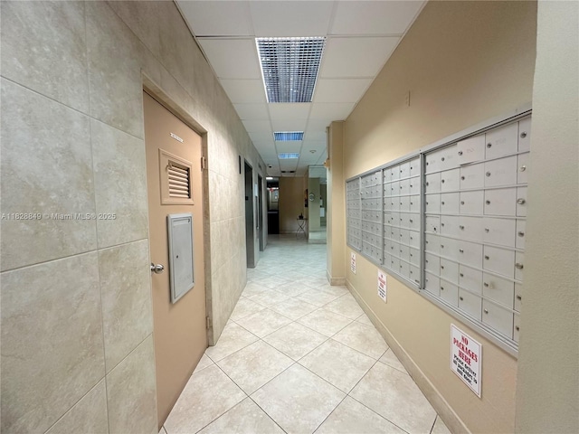 900 NE 18th Ave Unit 304, Fort Lauderdale, FL 33304 - hall with mail area, light tile patterned floors, tile walls, and a drop ceiling