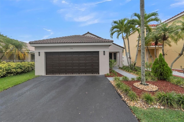 1592 Salerno Cir, Weston, FL 33327 - view of front of home with stucco siding, asphalt driveway, a garage, and a tile roof