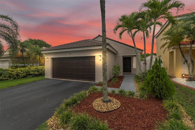 1592 Salerno Cir, Weston, FL 33327 - view of front facade with stucco siding, a garage, a tile roof, and driveway