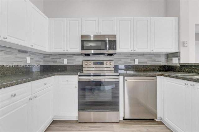 1592 Salerno Cir, Weston, FL 33327 - kitchen featuring stainless steel appliances, white cabinetry, decorative backsplash, and light wood-type flooring