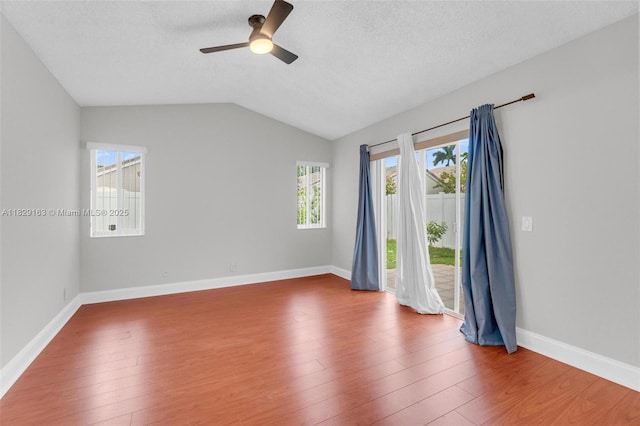 1592 Salerno Cir, Weston, FL 33327 - unfurnished room with ceiling fan, wood finished floors, lofted ceiling, and a textured ceiling