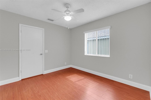 1592 Salerno Cir, Weston, FL 33327 - empty room featuring ceiling fan, wood finished floors, and a textured ceiling