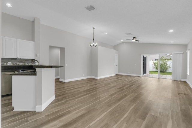 1592 Salerno Cir, Weston, FL 33327 - unfurnished living room featuring light wood-type flooring, a chandelier, a ceiling fan, recessed lighting, and high vaulted ceiling
