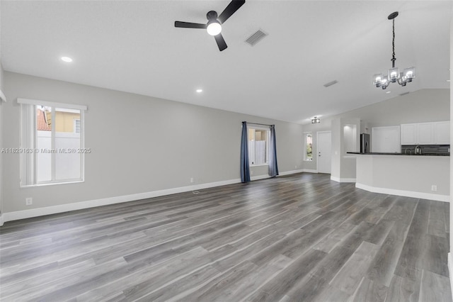 1592 Salerno Cir, Weston, FL 33327 - unfurnished living room featuring ceiling fan, lofted ceiling, a chandelier, wood finished floors, and recessed lighting