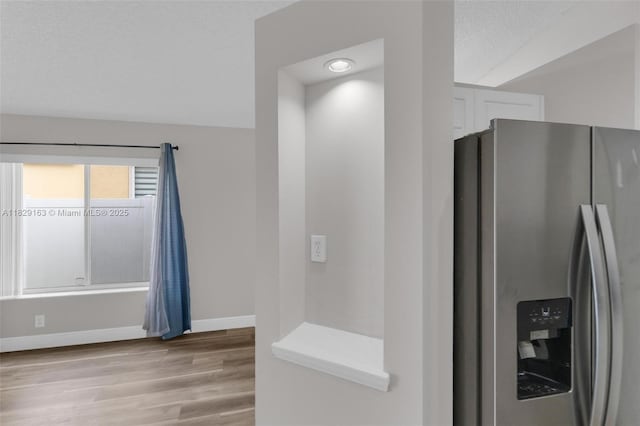 1592 Salerno Cir, Weston, FL 33327 - kitchen featuring stainless steel fridge with ice dispenser, white cabinets, light wood-style floors, and light countertops