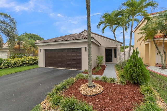 1592 Salerno Cir, Weston, FL 33327 - view of front of property featuring a garage, a tiled roof, stucco siding, and asphalt driveway