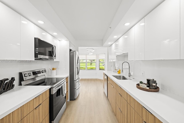 550 SW 138th Ave Unit 112K, Pembroke Pines, FL 33027 - kitchen with modern cabinets, appliances with stainless steel finishes, light wood finished floors, white cabinetry, and recessed lighting