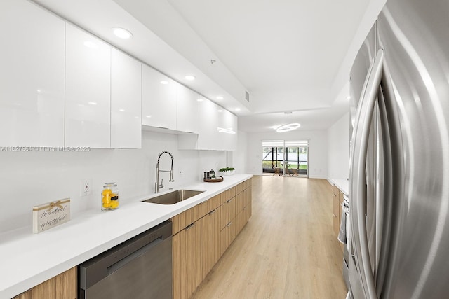 550 SW 138th Ave Unit 112K, Pembroke Pines, FL 33027 - kitchen with appliances with stainless steel finishes, modern cabinets, white cabinetry, light wood finished floors, and light countertops