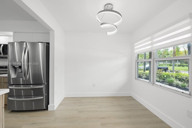 550 SW 138th Ave Unit 112K, Pembroke Pines, FL 33027 - unfurnished dining area with baseboards and light wood-type flooring