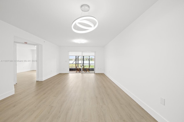 550 SW 138th Ave Unit 112K, Pembroke Pines, FL 33027 - empty room with light wood finished floors and a chandelier