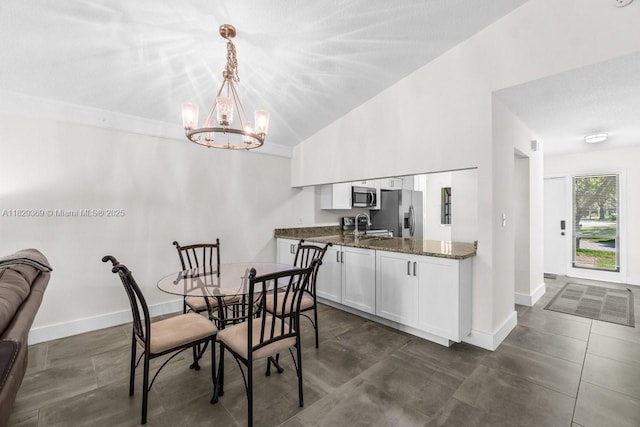 3693 N Arelia Dr N, Delray Beach, FL 33445 - dining area featuring a chandelier, lofted ceiling, and a textured ceiling