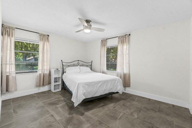 3693 N Arelia Dr N, Delray Beach, FL 33445 - bedroom with ceiling fan and a textured ceiling