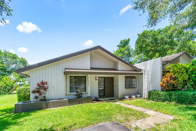 3693 N Arelia Dr N, Delray Beach, FL 33445 - mid-century modern home featuring a front lawn
