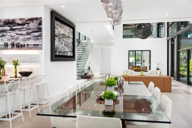 1410 S Biscayne Point Rd, Miami Beach, FL 33141 - dining space featuring healthy amount of natural light, wood finished floors, recessed lighting, and stairs