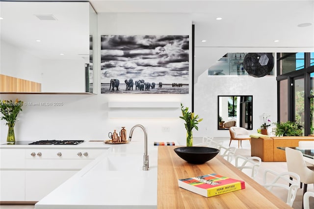 1410 S Biscayne Point Rd, Miami Beach, FL 33141 - kitchen with white cabinets, modern cabinets, light countertops, gas stovetop, and recessed lighting