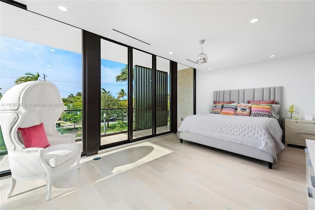 1410 S Biscayne Point Rd, Miami Beach, FL 33141 - bedroom featuring a wall of windows, wood finished floors, and recessed lighting