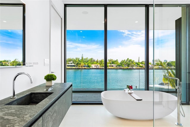1410 S Biscayne Point Rd, Miami Beach, FL 33141 - full bathroom featuring healthy amount of natural light, a freestanding bath, and a water view