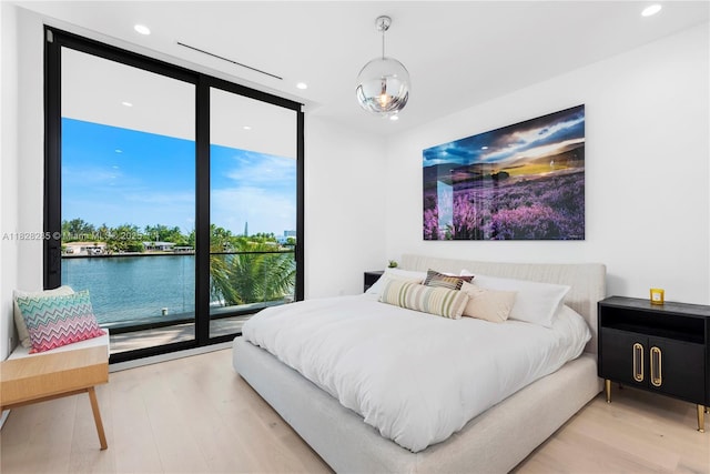 1410 S Biscayne Point Rd, Miami Beach, FL 33141 - bedroom featuring floor to ceiling windows, light wood finished floors, recessed lighting, and access to outside