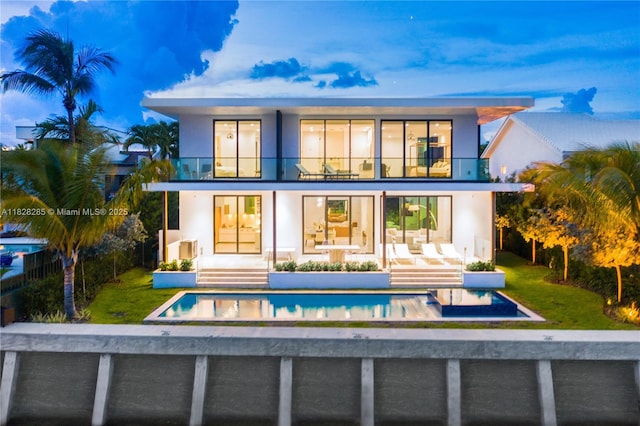 1410 S Biscayne Point Rd, Miami Beach, FL 33141 - back of house with a balcony, stucco siding, and an outdoor pool