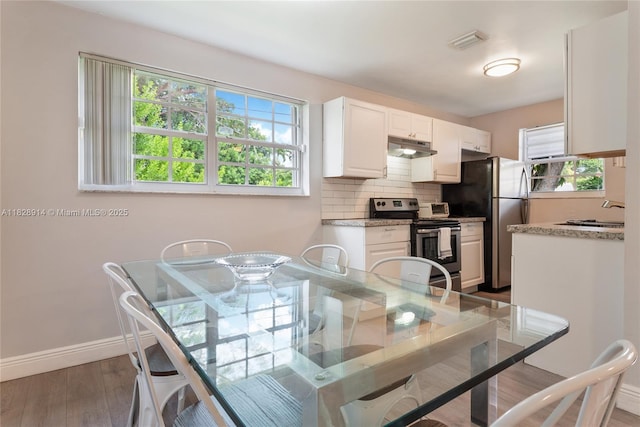 6198 SW 63rd St, South Miami, FL 33143 - dining room with baseboards and wood finished floors