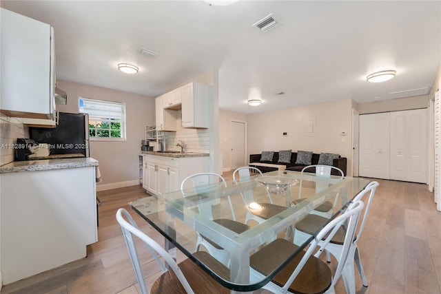 6198 SW 63rd St, South Miami, FL 33143 - dining room with light wood-type flooring and baseboards