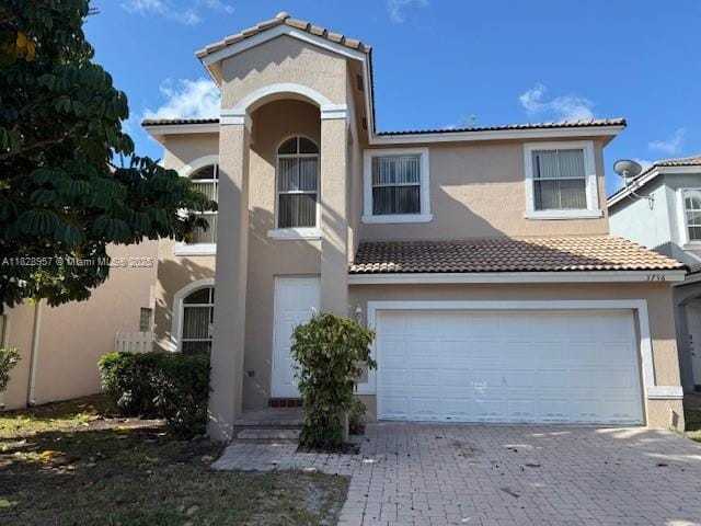 3736 SW 50th St, Hollywood, FL 33312 - view of front of property featuring stucco siding, a tile roof, an attached garage, and decorative driveway