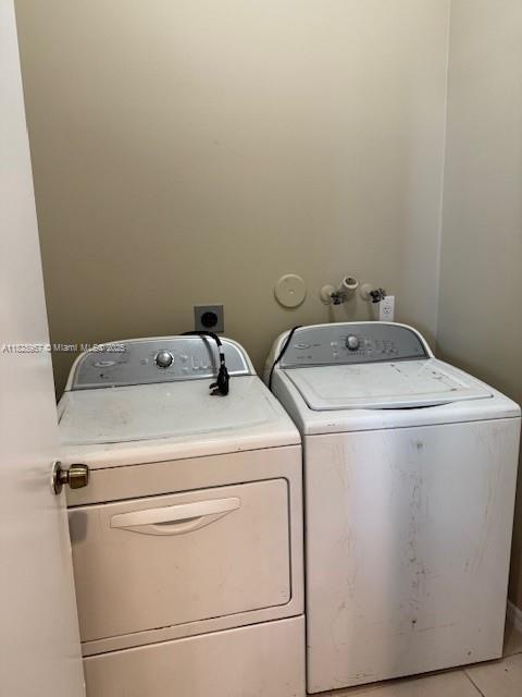 3736 SW 50th St, Hollywood, FL 33312 - laundry area with washing machine and dryer and light tile patterned flooring