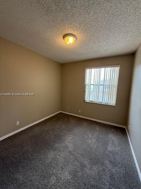 3736 SW 50th St, Hollywood, FL 33312 - spare room featuring dark carpet and a textured ceiling