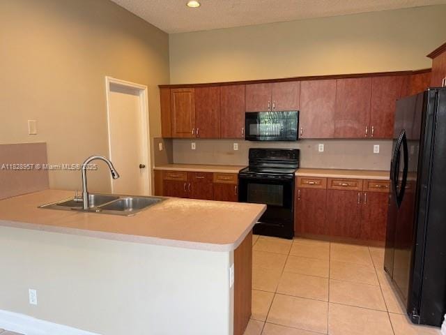 3736 SW 50th St, Hollywood, FL 33312 - kitchen with black appliances, light countertops, light tile patterned floors, brown cabinetry, and recessed lighting