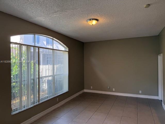 3736 SW 50th St, Hollywood, FL 33312 - unfurnished room featuring a textured ceiling and tile patterned flooring