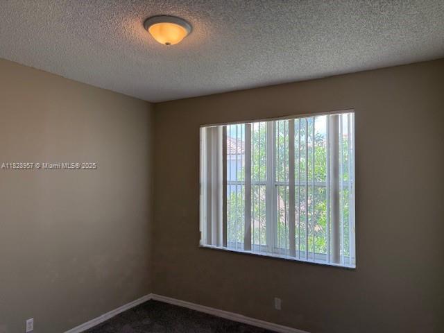 3736 SW 50th St, Hollywood, FL 33312 - unfurnished room with a textured ceiling and dark carpet