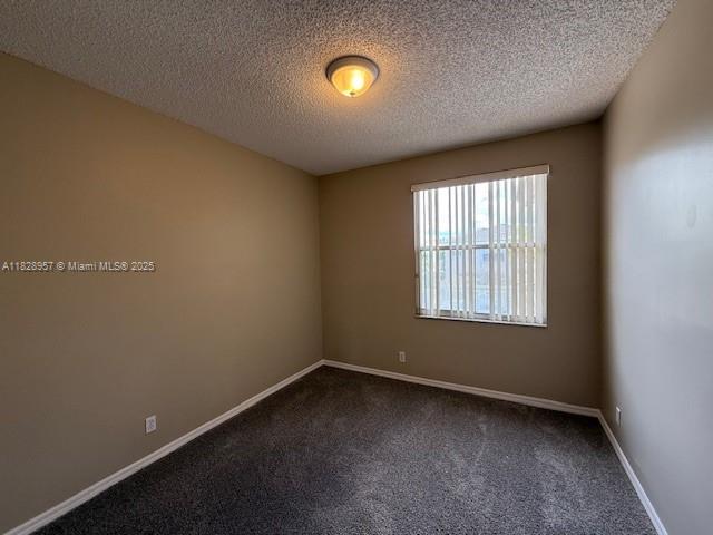 3736 SW 50th St, Hollywood, FL 33312 - spare room with dark colored carpet and a textured ceiling