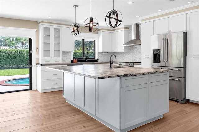 9745 SW 126th Ter, Miami, FL 33176 - kitchen with wall chimney range hood, high end refrigerator, decorative backsplash, white cabinetry, and recessed lighting