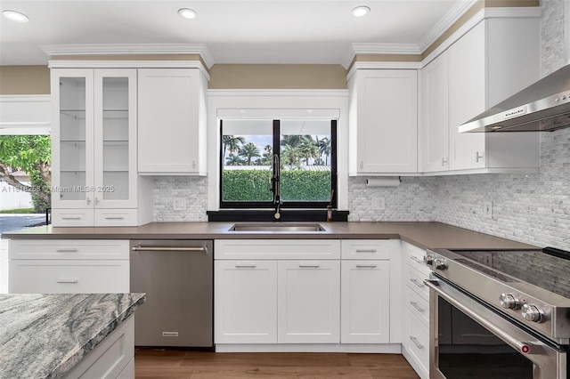 9745 SW 126th Ter, Miami, FL 33176 - kitchen with appliances with stainless steel finishes, wall chimney range hood, white cabinets, decorative backsplash, and recessed lighting