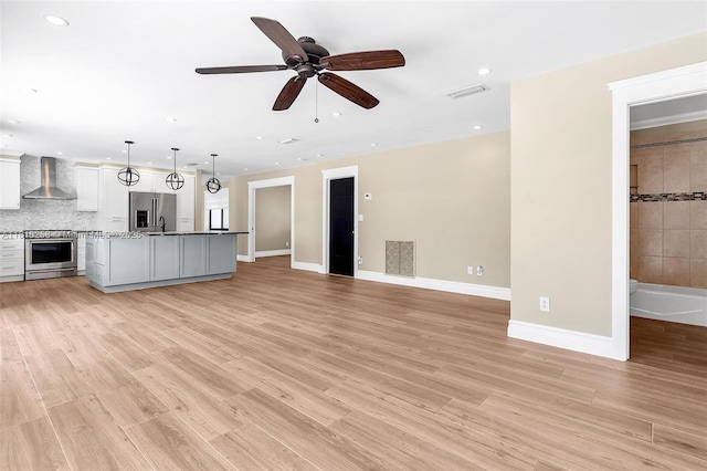 9745 SW 126th Ter, Miami, FL 33176 - unfurnished living room featuring recessed lighting, light wood-style floors, and a ceiling fan